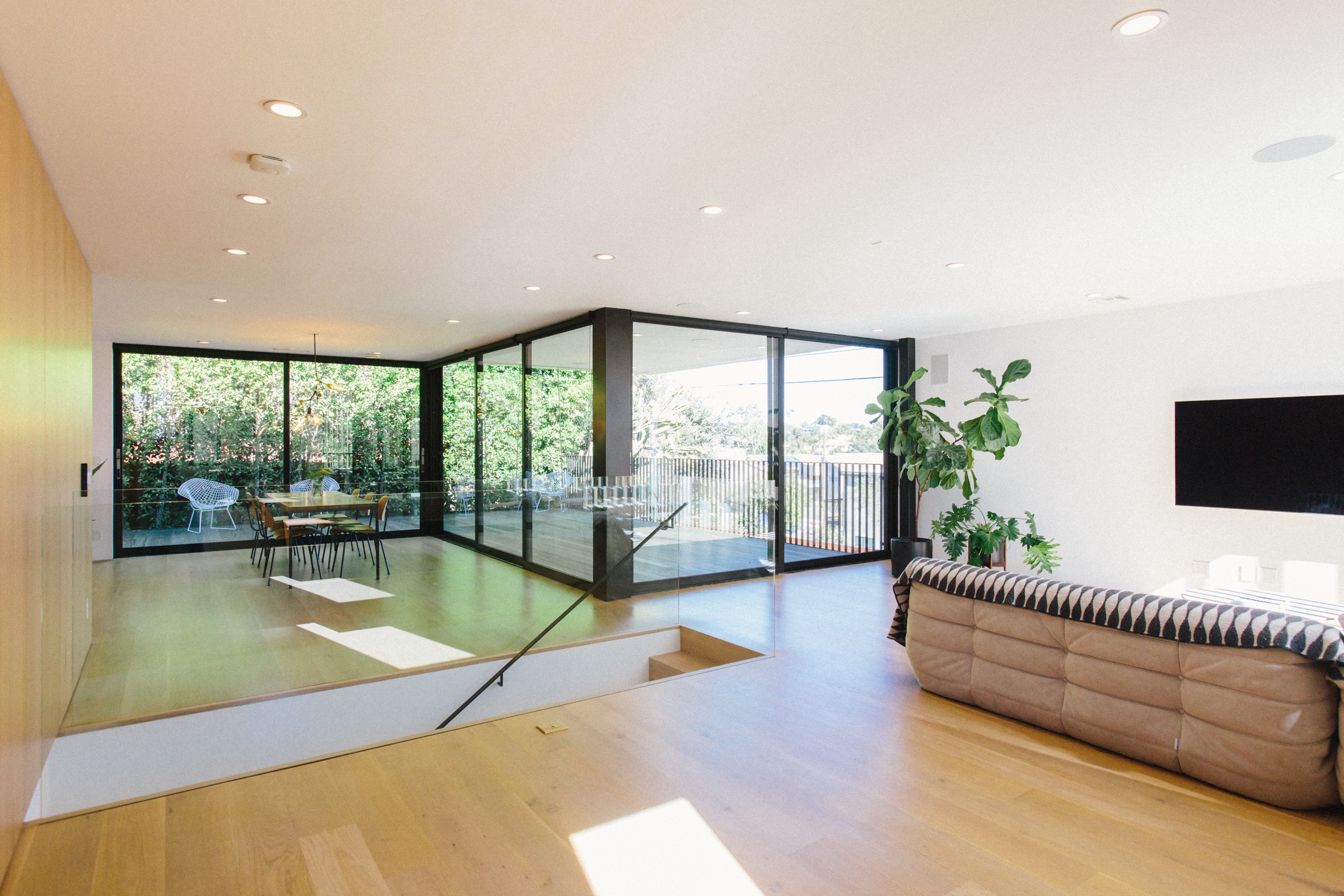 Living room with glass walls opening to the terrace