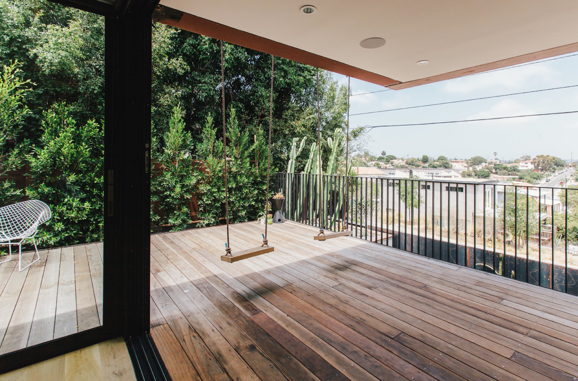 Deck with rope swings and railing overlooking the neighborhood