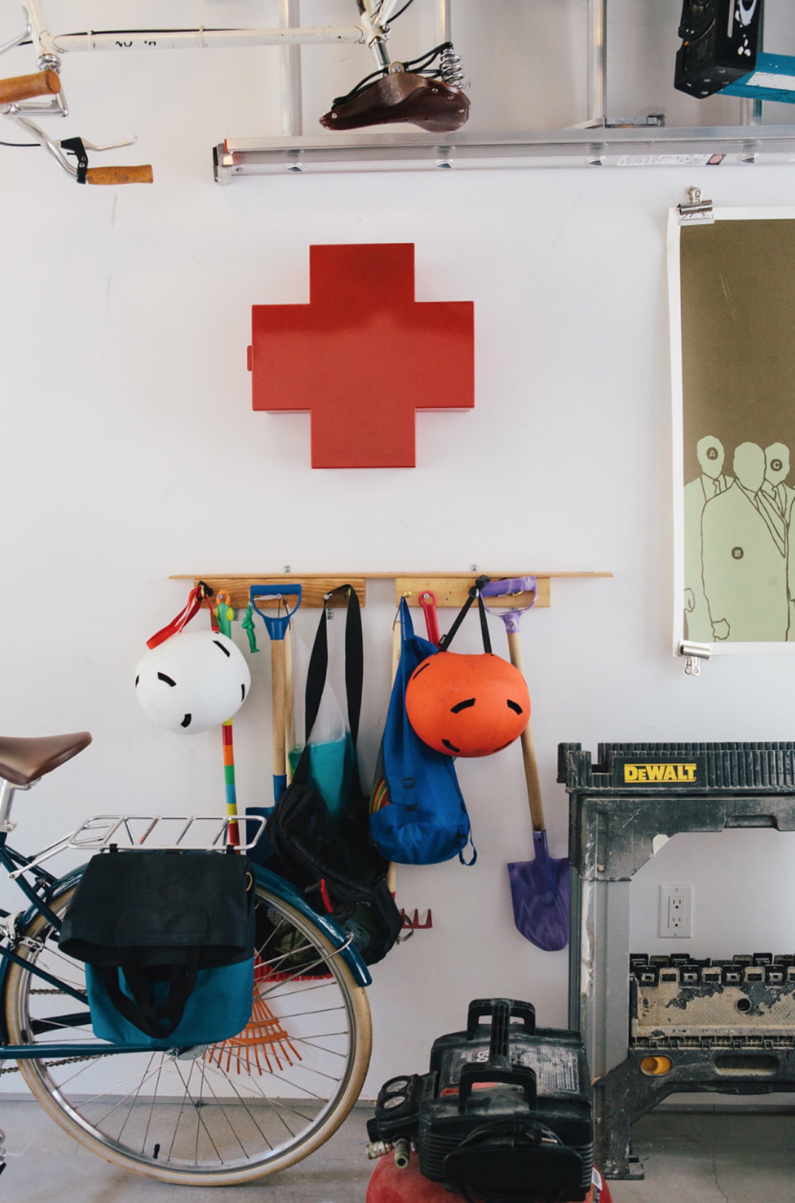 Garage wall with red cross cabinet, bikes, and tool bench