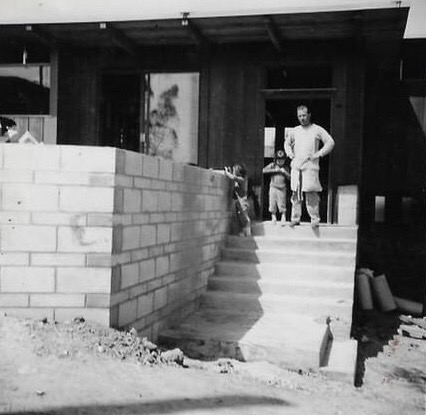 Brick wall going up at the entrance, March 1955